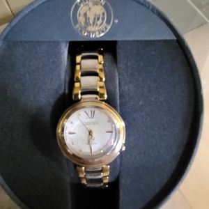 Citizens women's Eco-Drive watch with a pearl face and gold trim and a gold hand